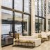 Abaton Island Resort & Spa in Hersonissos, airy lobby with lounge seating and a staircase under string lights