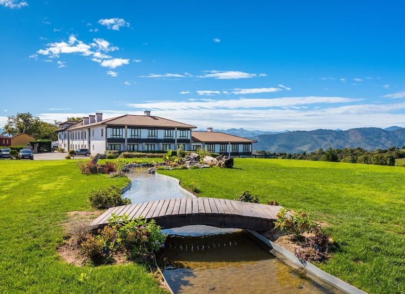 Hosteria de Torazo Nature Hotel & Spa in Torazo with mountain views and a landscaped garden path
