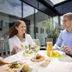 Guests dining in a glass-enclosed restaurant at Kosta Boda Art Hotel, Kosta