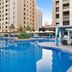 Mövenpick Hotel Jumeirah Beach in Dubai with a large outdoor pool and surrounding lounge chairs