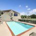 Microtel Inn & Suites by Wyndham Ponchatoula/Hammond outdoor pool with patio seating in Ponchatoula
