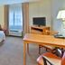 Candlewood Suites Fort Stockton room with bed, desk, TV and window air unit in Fort Stockton