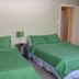 Mountain Harbor Resort and Spa in Mount Ida: guest room with two green polka-dot beds and bedside lamp