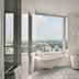 Four Seasons Hotel Bengaluru at Embassy One bathroom with freestanding tub and city view