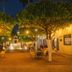 La Casa de Mamapán Hotel Colonial Ahuachapan courtyard with trees, tables and a lit fountain at night