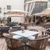 Az Hôtels Zeralda outdoor terrace with seating, umbrellas and waterfall feature in Zeralda