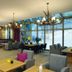 Hotel Fire & Ice Düsseldorf/Neuss in Neuss lounge with dining area and large floor-to-ceiling windows