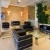 Hotel La Boroña lobby lounge with black leather chairs and indoor plants in Gijón