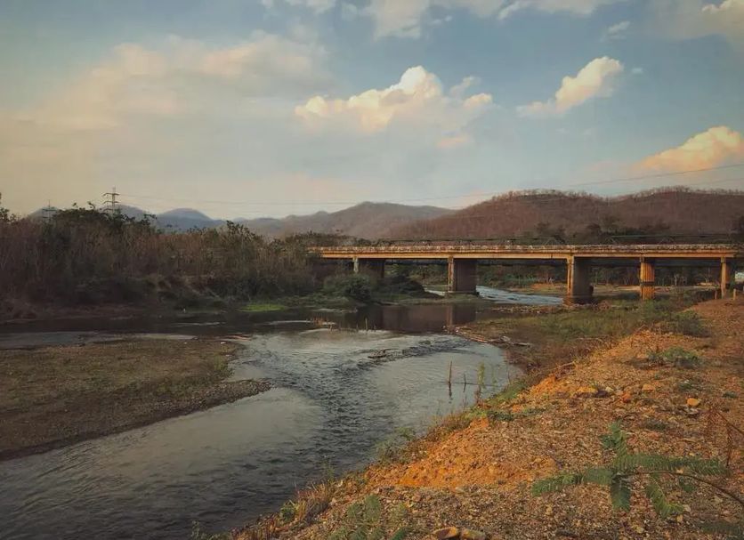 Kalm Pai in Pai with a river view and bridge at sunset