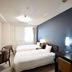 Chisun Hotel Koriyama guest room with two single beds, desk, chairs, and window in Kōriyama