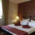 Hotel Snorrenburg Gmbh in Burbach guest room with double bed, bedside lamps and patterned wall