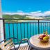 Onda D'oro Hostel in Yeosu balcony with table, chairs, and panoramic ocean and mountain view