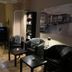 Hotel Lindenhof in Bad Gastein lounge with black chairs, tables, stools, fairy lights, and wall art