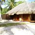 Hotel Le Mahana in Huahine: thatched beachfront bungalow surrounded by palm trees