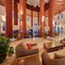 Sandos Papagayo Beach Resort lobby lounge in Playa Blanca with wicker seating and tall atrium windows