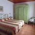 Borgo Degli Aranci room in San Giuliano Terme with twin beds, wardrobe, chair and tiled floor