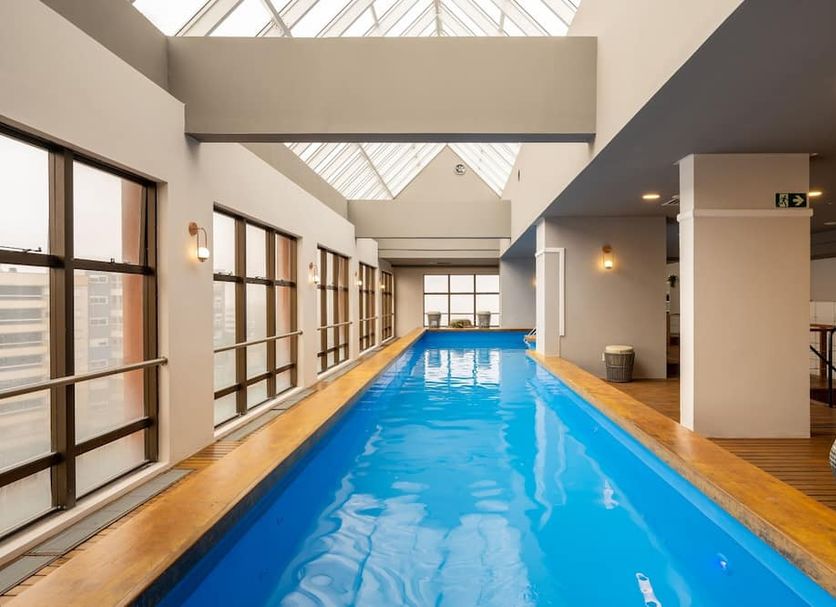 Intercity Caxias do Sul indoor lap pool with skylight and city-view windows