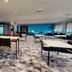 Village Hotel Newcastle in Newcastle upon Tyne dining area with tables, chairs and blue accent wall