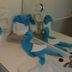 Karibu Aruba in Noord: bathroom sink with blue-and-white folded towel swans and tissue box