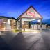 Red Roof Inn & Suites Duncan exterior at dusk with illuminated entrance and parking lot