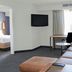 Residence Inn by Marriott Colorado Springs North/Air Force Academy suite with sofa, desk, wall TV and bedroom doorway