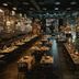 Pierdrei Hotel Hafencity Hamburg restaurant with long communal tables and warm industrial lighting in Hamburg