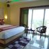 Hotel Sagar Kanya Inn, Puri: bedroom with king bed, balcony chairs and ocean view