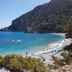 Arkasa Palace in Arkása with sea-view bay, sandy beach, turquoise water, and hillside coastline