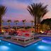 The Canyon Suites at The Phoenician, Scottsdale poolside lounge with palm trees at sunset