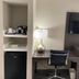 Baymont by Wyndham Topeka room with TV, desk, lamp, and mini fridge