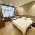 Dream 8 Business Hotel in Taizhou guest room with a bed, chaise lounge and large window
