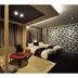 Hotel Obokekyo Mannaka room in Miyoshi with twin beds and a red low table