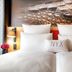 NYX Hotel Munich by Leonardo Hotels guest room with a bed, wall art and bedside lamps