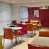 Premiere Classe Metz Nord - Semecourt breakfast room with colorful chairs and tables in Semécourt