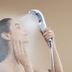 Toyoko Inn Toyohashi eki Higashi guchi showering guest using handheld showerhead in bathroom
