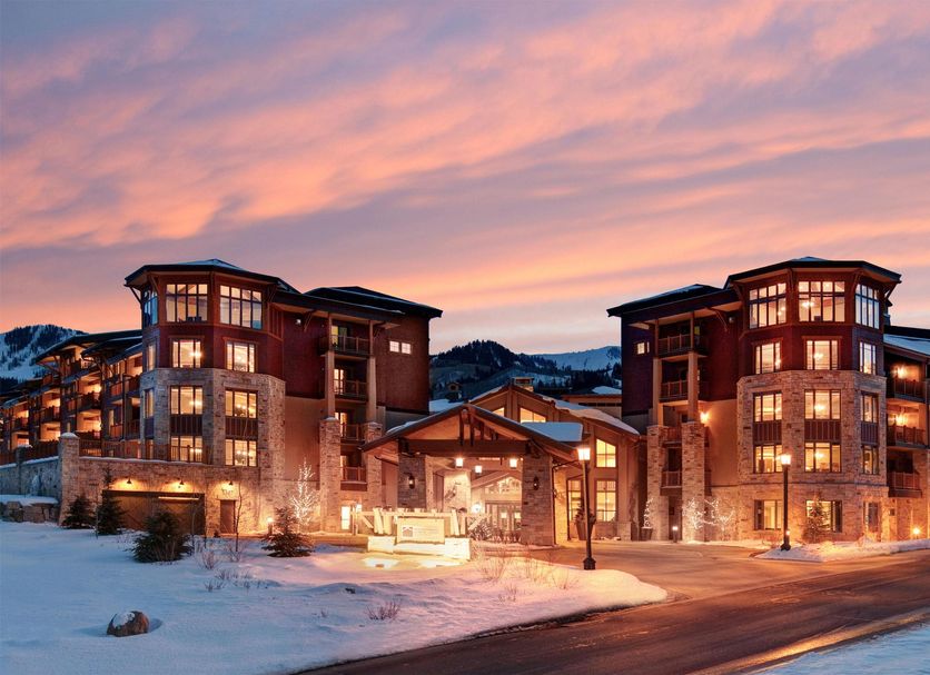 Hilton Grand Vacations Club Sunrise Lodge Park City exterior at sunset with snowy mountain setting