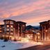 Hilton Grand Vacations Club Sunrise Lodge Park City exterior at sunset with snowy mountain setting