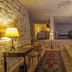 Yunak Evleri Cappadocia in Ürgüp: cave room with stone walls, rugs, lamps, and two beds
