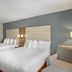 Best Western Porterville Inn guest room with two queen beds and an armchair in Porterville