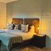 River Crossing Lodge, Windhoek guest room with twin beds and large window overlooking trees