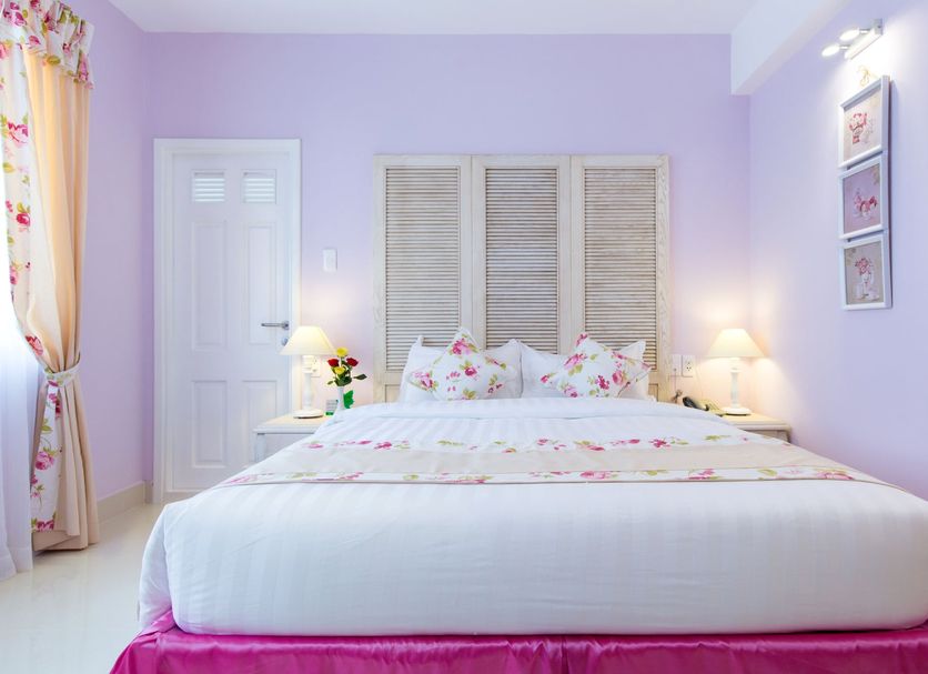 Hotel L Odeon Phu My Hung room with pastel decor and a king bed in Ho Chi Minh City