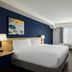 City Express by Marriott Washington, DC Northeast guest room with king bed, desk, chair, and window seating.