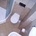 Hotel Stella di Mare in Bečići bathroom with glass shower, toilet, and tiled floor