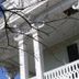 Dansereau House in Thibodaux with white columns and ornate balcony under blue sky