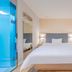 Hanting Hotel Shanghai Xujiahui Metro Station room with bed, mirror, and glass bathroom door in Shanghai