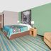 Super 8 by Wyndham Beaver Dam guest room with striped carpet, bed, armchair and green accent wall