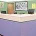 Super 8 by Wyndham Beaver Dam lobby front desk with pastel walls and guest computers