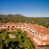 I Giardini di Cala Ginepro Hotel Resort in Cala Liberotto with landscaped courtyard and mountain views