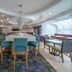 Hampton Inn by Hilton Hopewell Fort Lee lobby lounge with colorful seating, curved ceiling and TV