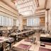 Pullman Shishi Mattison in Quanzhou: spacious hotel restaurant with chandeliers and arranged dining tables